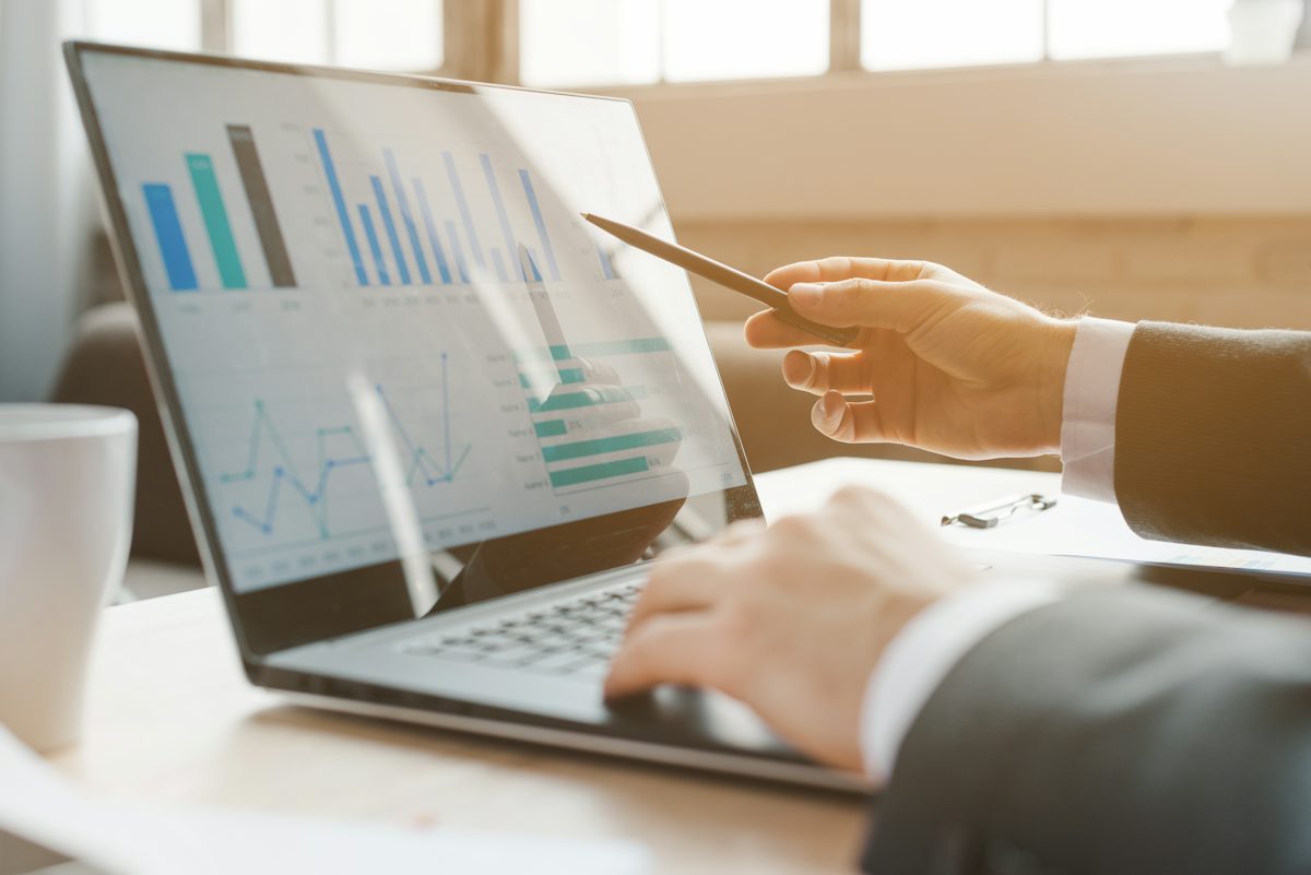 person analyzing business charts on laptop — illustrative stock photo