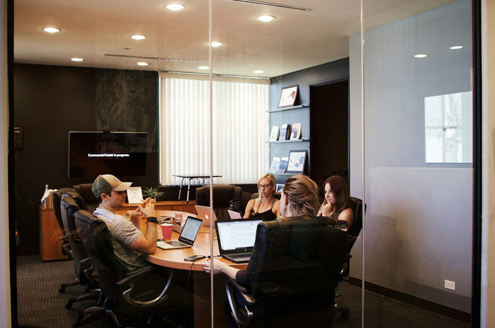 people sitting near table with laptop computer — illustrative stock photo