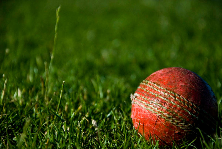 shallow focus photography of red cricket ball — illustrative stock photo