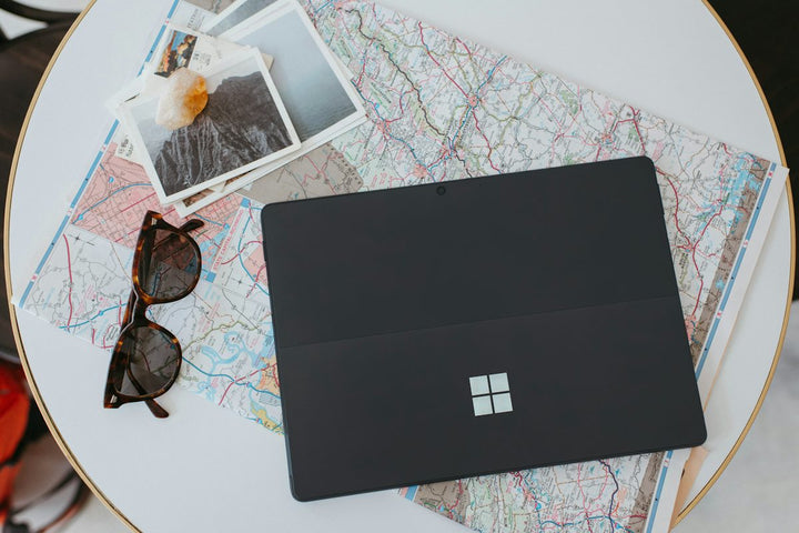 a laptop computer sitting on top of a white table — illustrative stock photo