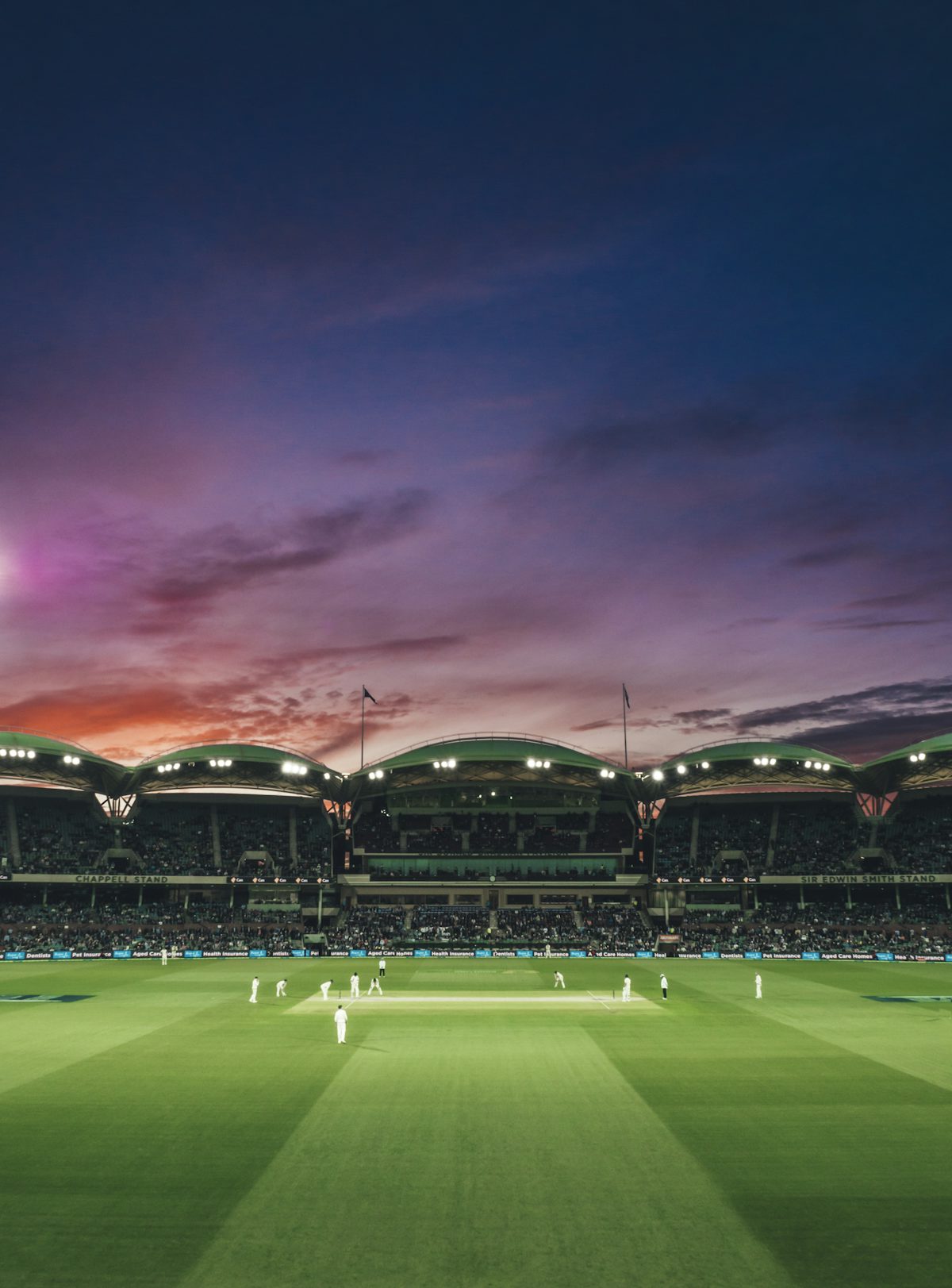 Cricket players on a field at Adelaide Oval in North Adelaide, Australia — illustrative stock photo
